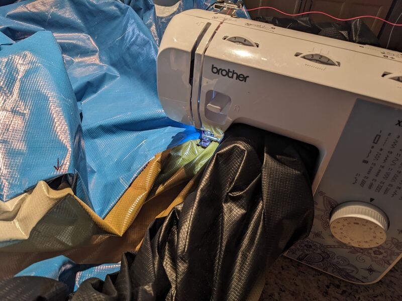 Vinyl tarp rolled under my sewing machine arm